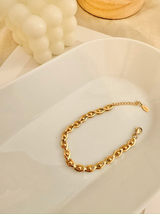 Pulsera cadena ojos dorados